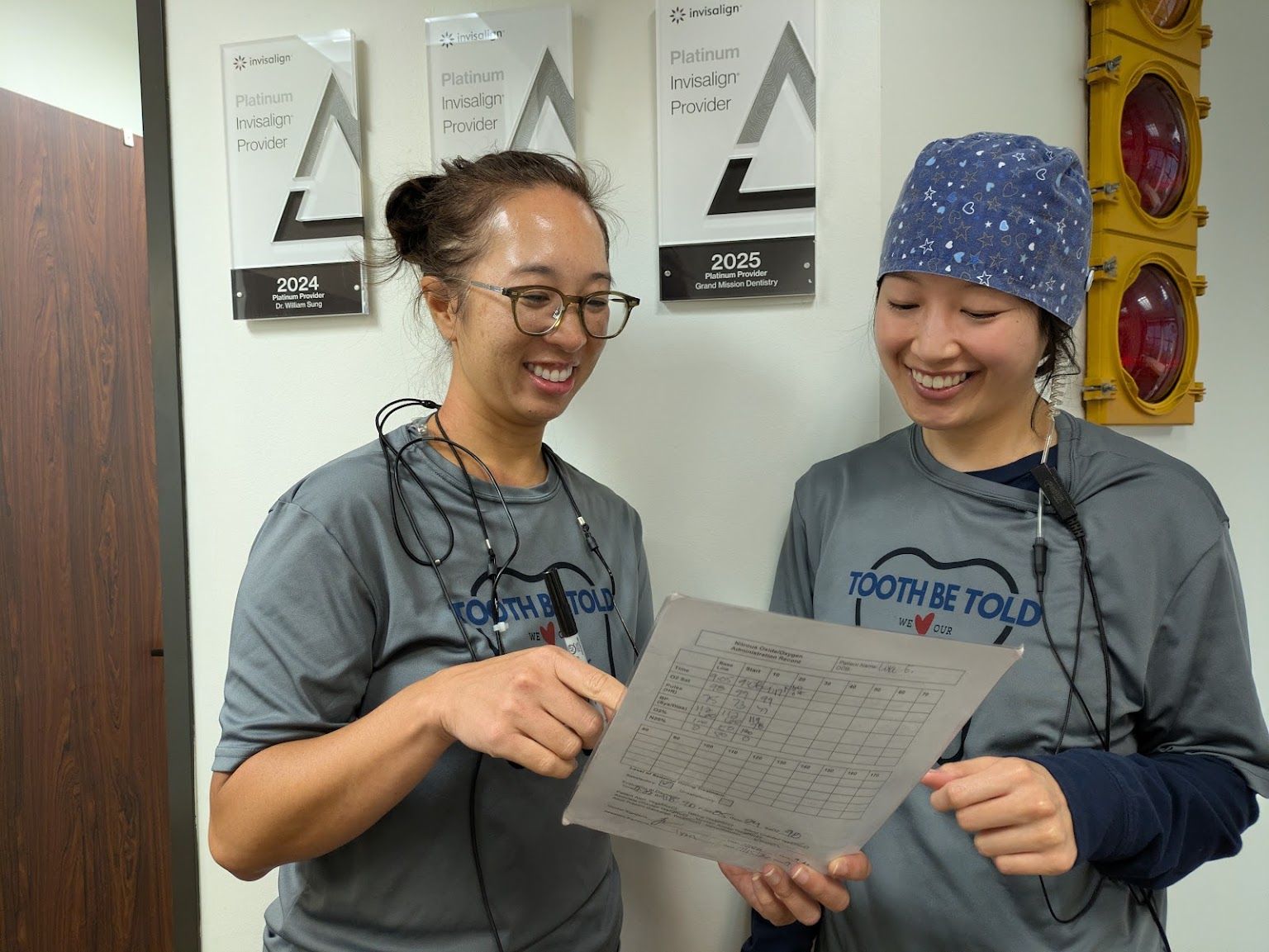 Two of the team under the practice's award plaques