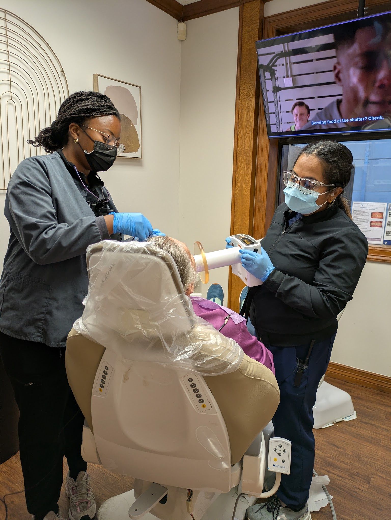 Two of the clinical team with a patient in the chair