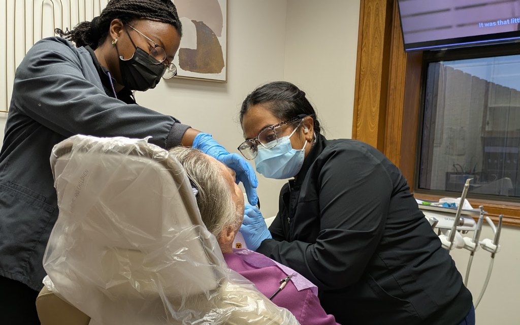 Two of the clinical team with an older patient in the chair
