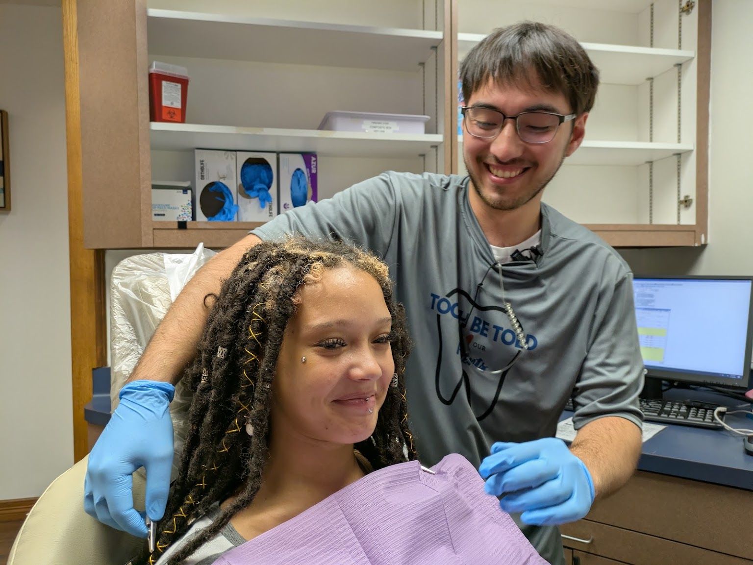 A young patient smiling in the chair
