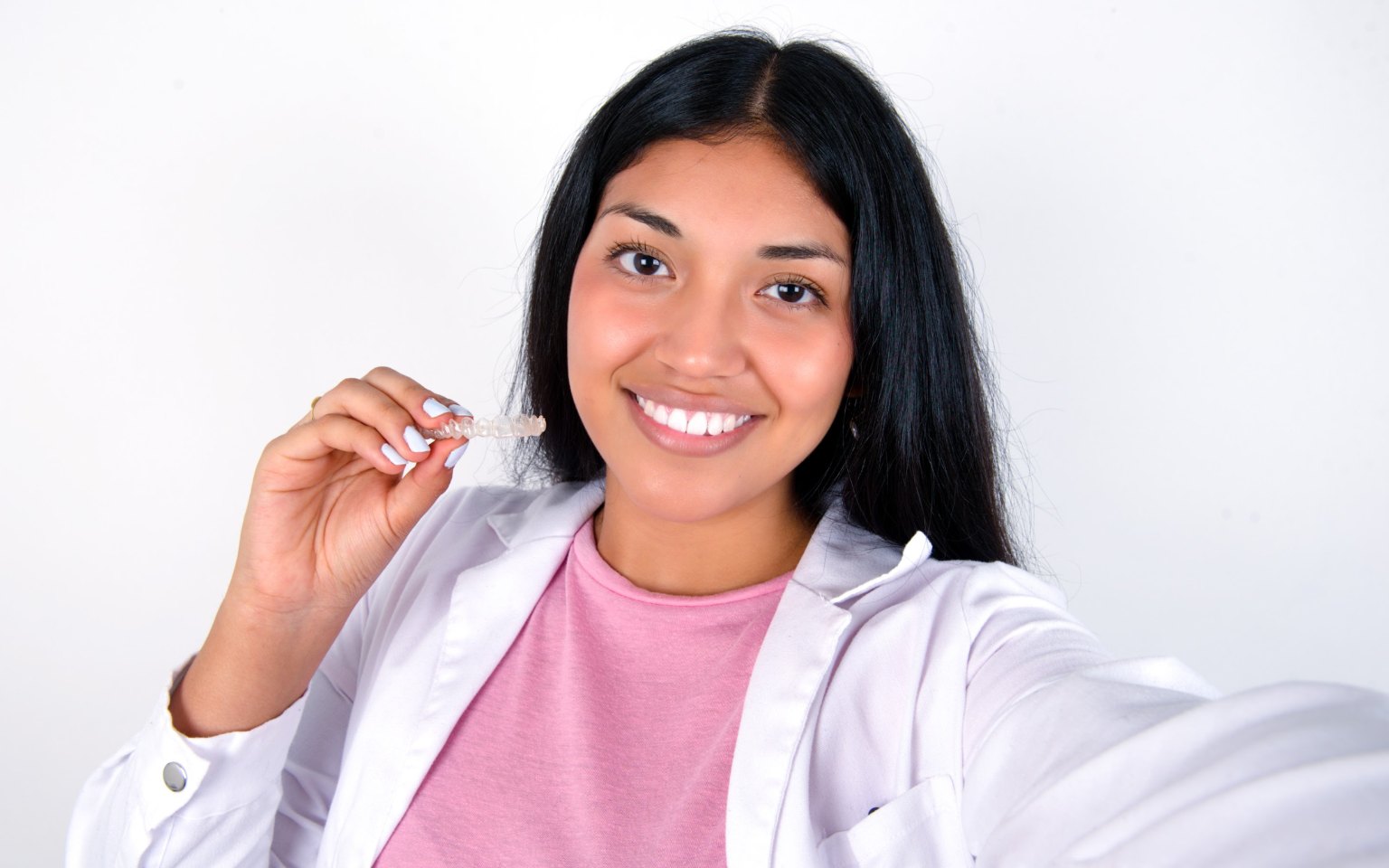 A smiling woman holding up a clear custom guard