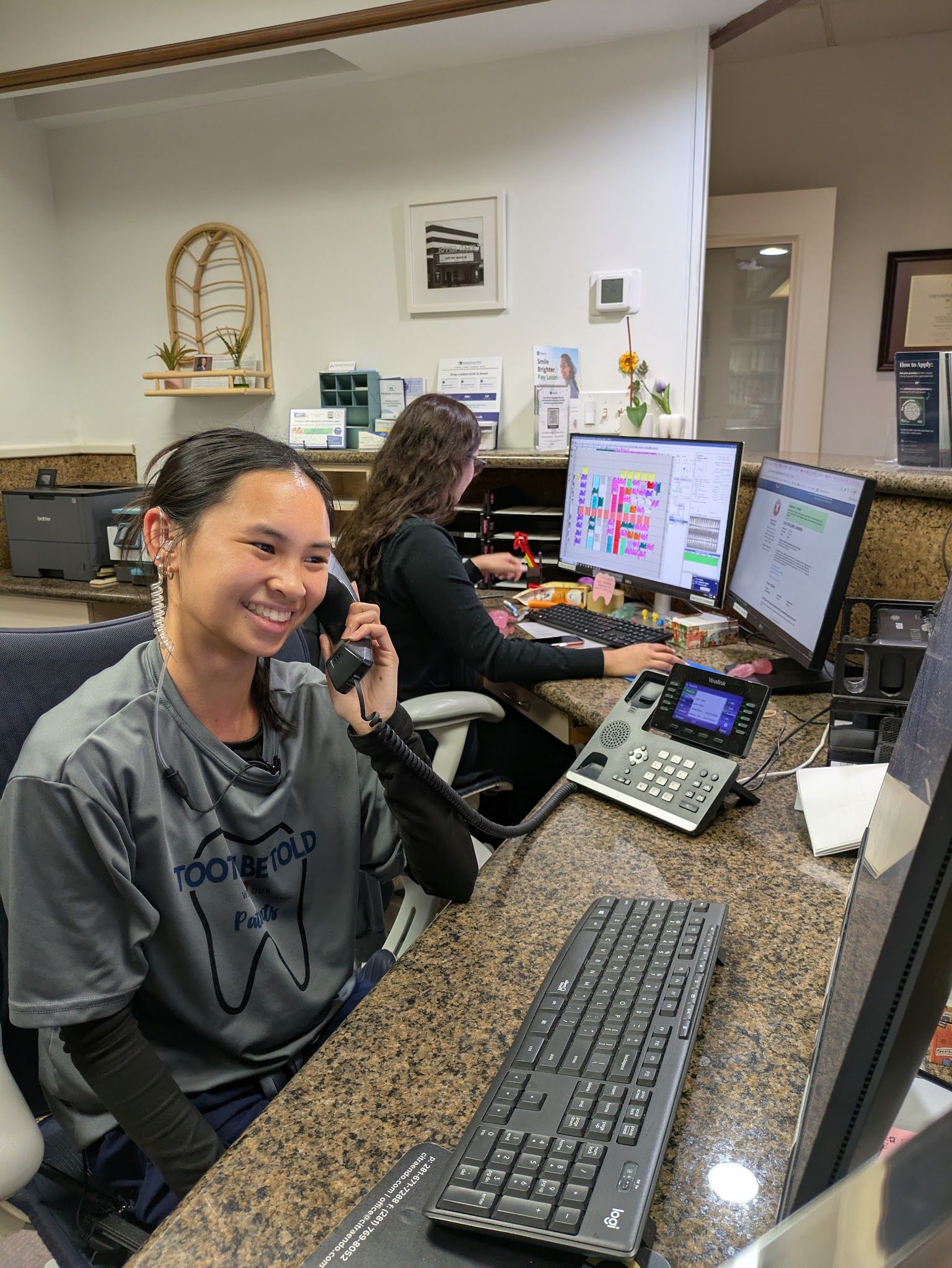 A member of the front desk on the phone
