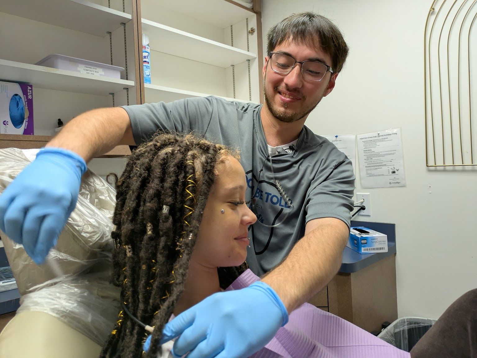 A dentist and a young patient getting ready for a check up