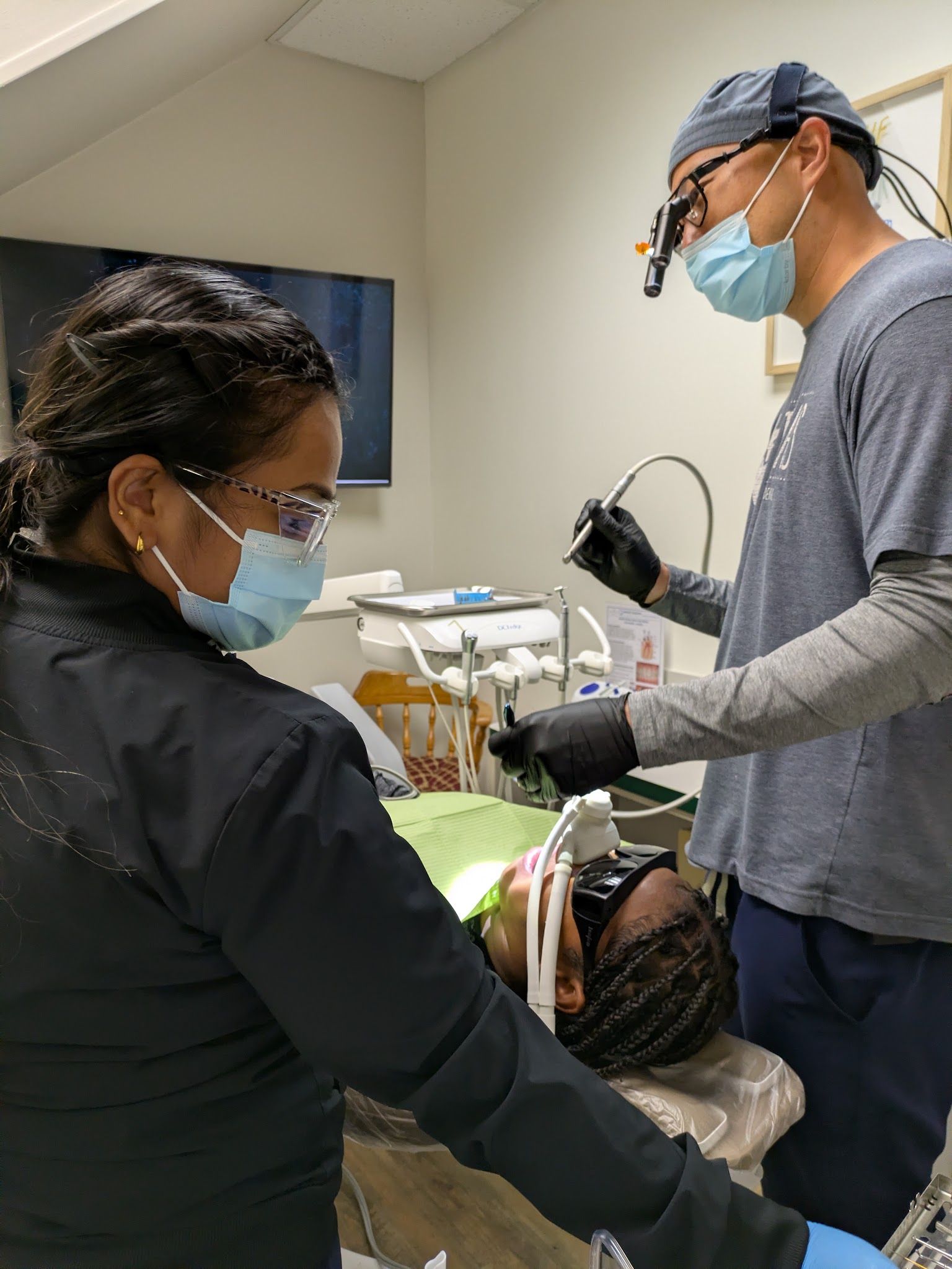 A hygienist at the chair in a treatment room